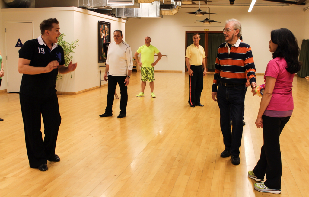 Instructor Jamie tells the dancers to relax and enjoy while rehearsing the steps from the west coast swing. 