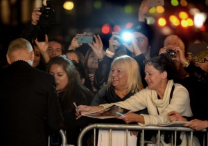 Fans receive autographs from Michael Keaton as he arrives. 