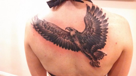 AUSB Student displaying her eagle tattoo on her back