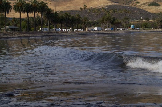 Black waves at Refugio State Beach North of Santa Barbara. A 24-inch ruptured pipeline leaked 21,000 gallons of oil into the Pacific Ocean (Photo Courtesy: Tamlorn Chase)