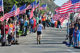 The Final Mile lined with people and American Flags to cheer runners on