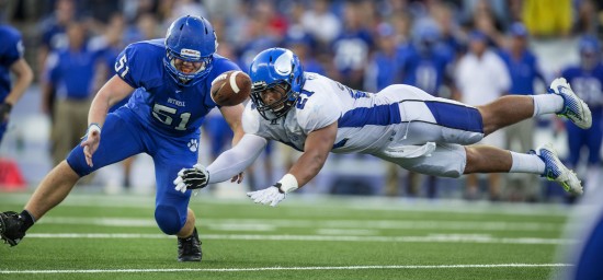 The first try glances off the fingertips of Chase Blakley (right), defended by the Cougars' Henry Gustin